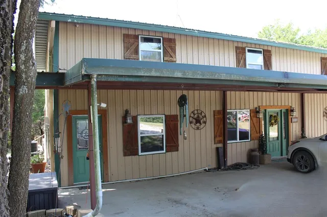 a view of a house with floor to ceiling windows and a table