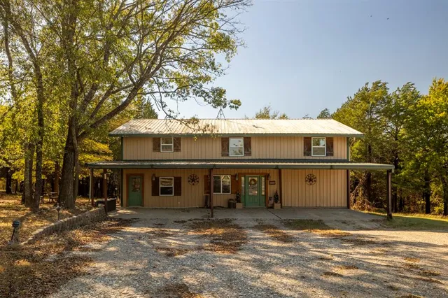 a front view of a building with a yard