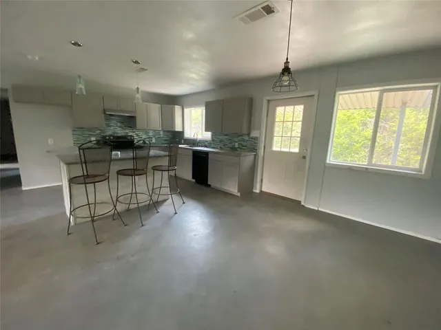a kitchen with granite countertop a sink and cabinets