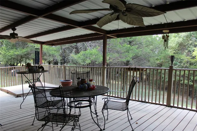 a view of a porch with furniture and wooden floor