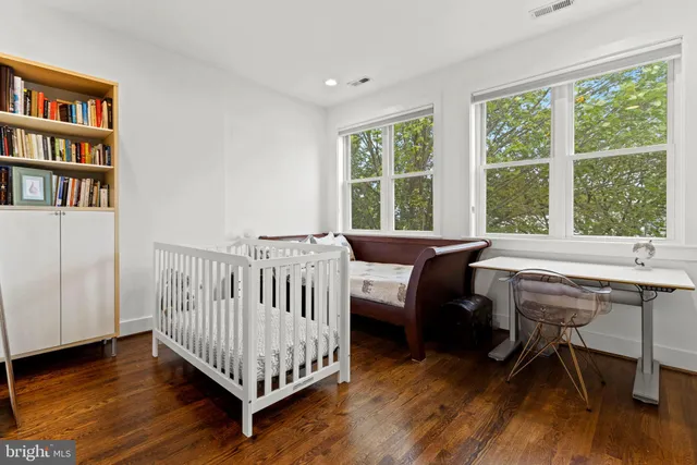 a view of a bedroom with furniture and a window