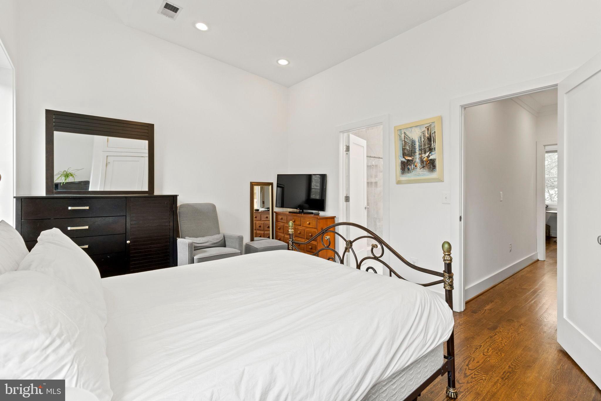 1928 First Street Northeast Washington, DC 20002 - Photo 17 of 26 a bedroom with a bed and a flat screen tv