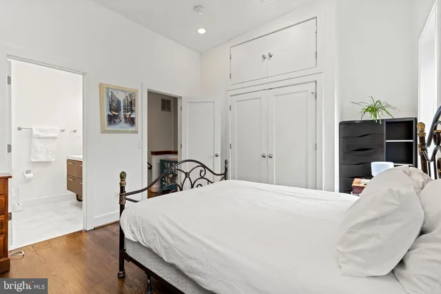 a bedroom with a bed and a dresser