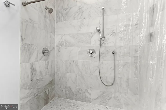 a bathroom with a bath shower