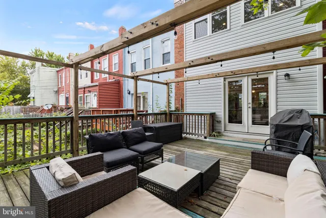 a balcony with furniture and wooden floor