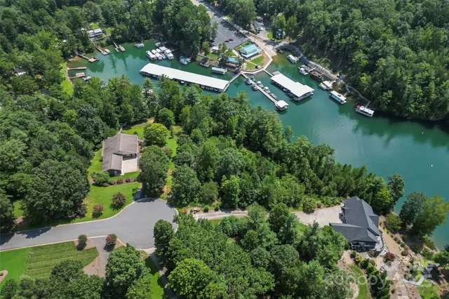 an aerial view of a house with a garden and lake view