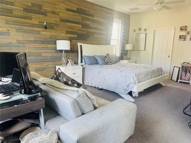 a bed room with a bed and a chair