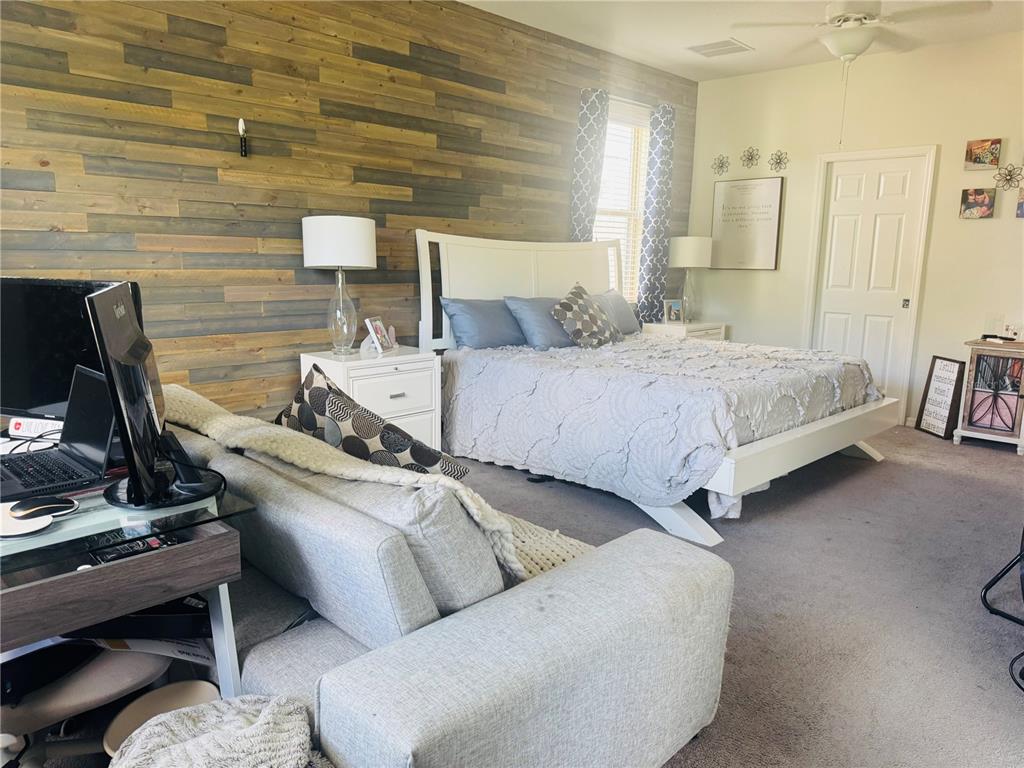 11626 Dublin Grafton Riverview, FL 33579 - Photo 14 of 32 a bed room with a bed and a chair