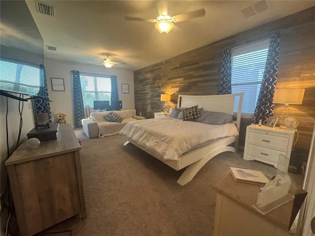 a bedroom with a bed and a couch