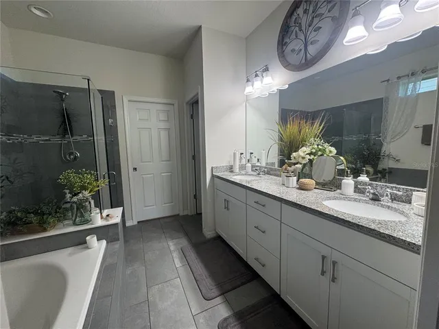 a spacious bathroom with a double vanity sink and a mirror
