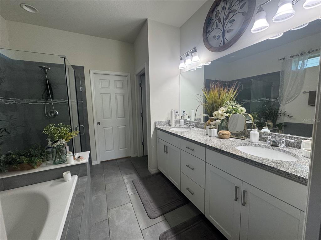 11626 Dublin Grafton Riverview, FL 33579 - Photo 19 of 32 a spacious bathroom with a double vanity sink and a mirror