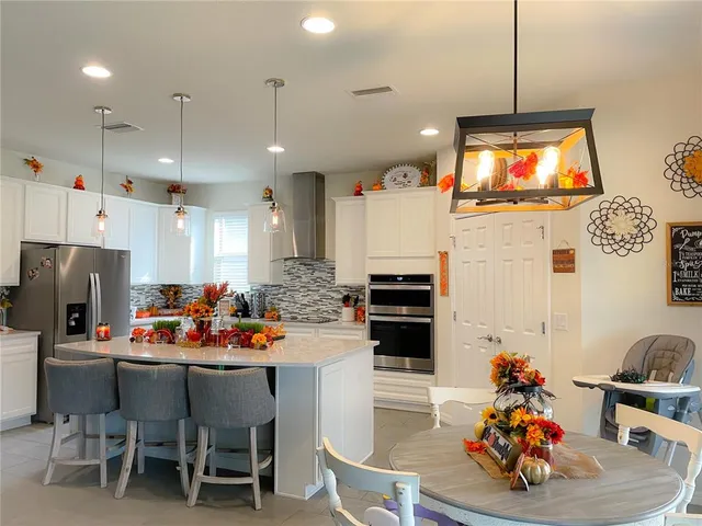 a kitchen that has a table and chairs in it