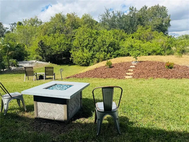 a view of an chairs and table in the garden