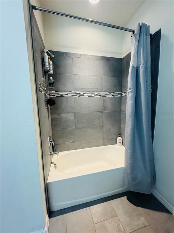 11626 Dublin Grafton Riverview, FL 33579 - Photo 7 of 32 a bathroom with a bathtub and a shower