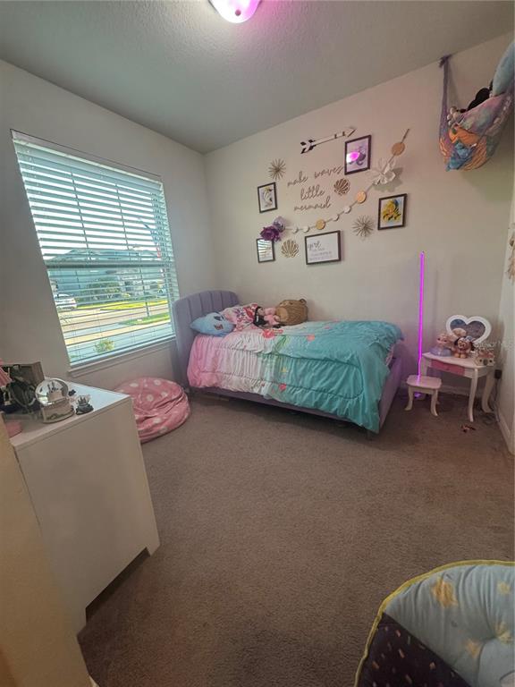 11626 Dublin Grafton Riverview, FL 33579 - Photo 9 of 32 a bedroom with two beds and a window