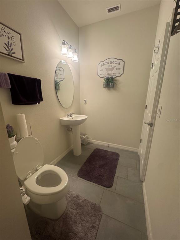 11626 Dublin Grafton Riverview, FL 33579 - Photo 10 of 32 a bathroom with a toilet a sink and a mirror
