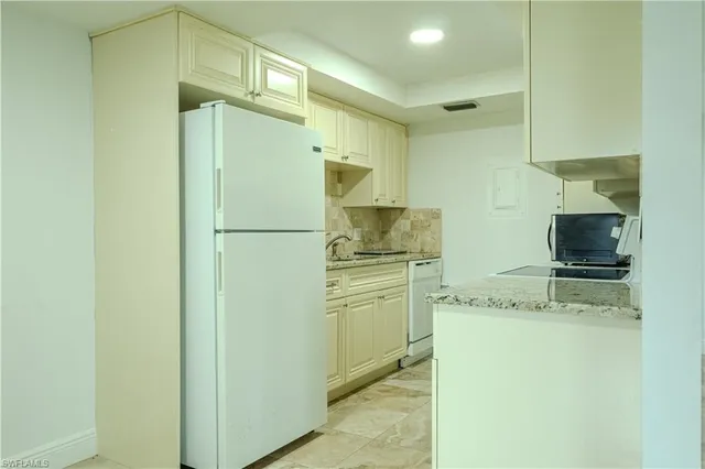 a kitchen with stainless steel appliances a refrigerator and a sink