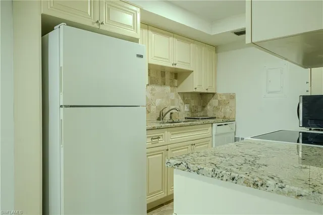 a kitchen with a refrigerator and a sink