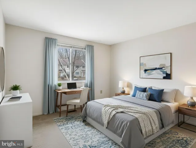 a bedroom with a large bed and a window