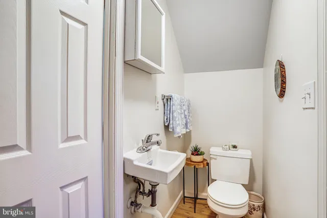 a white toilet sitting next to a bathroom sink