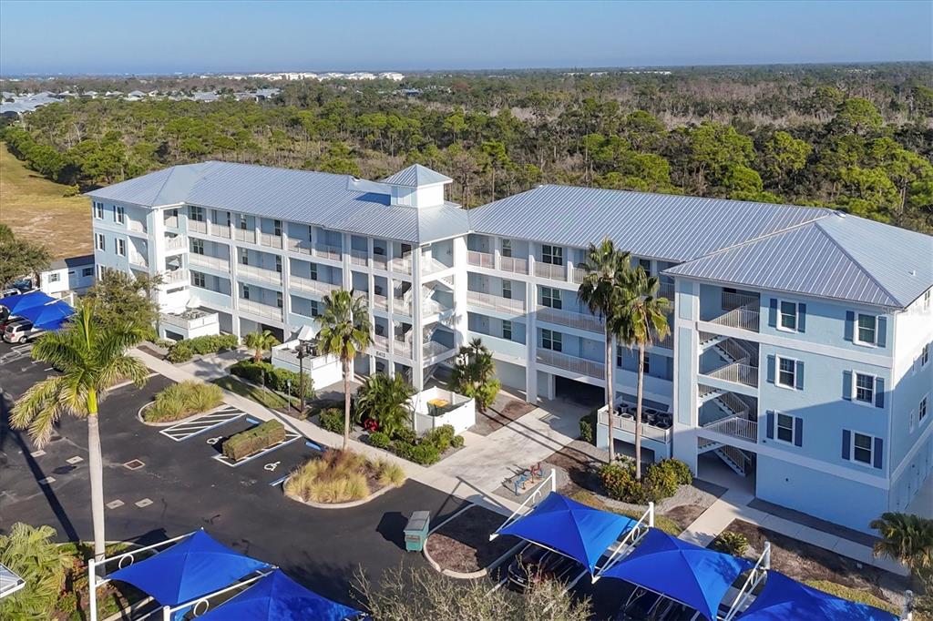 an aerial view of multiple houses with a yard