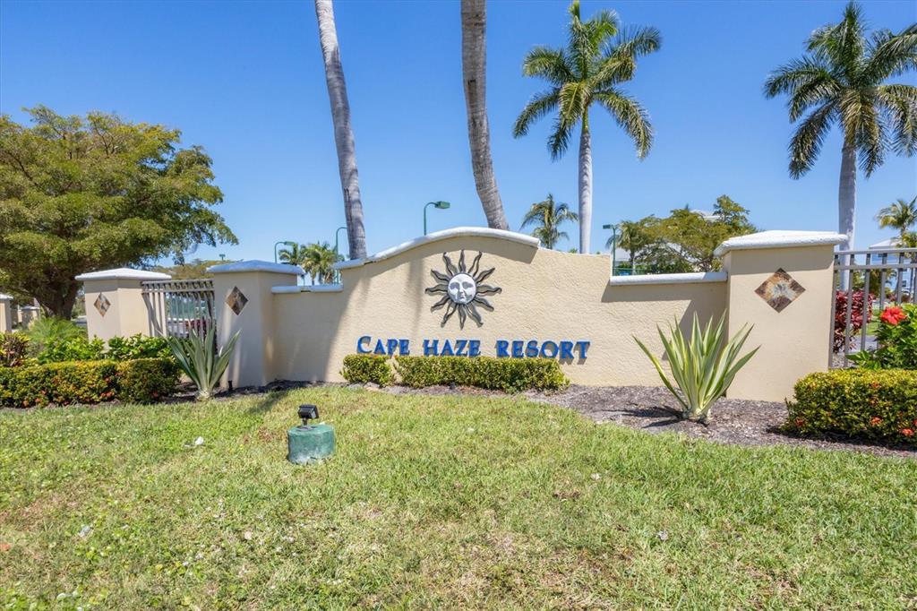 8413 Placida Road, Unit 407 Placida, FL 33946 - Photo 33 of 57 a view of front of house with sign board and yard