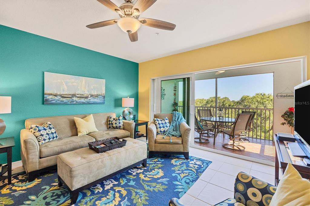 8413 Placida Road, Unit 407 Placida, FL 33946 - Photo 6 of 57 a living room with furniture and a flat screen tv