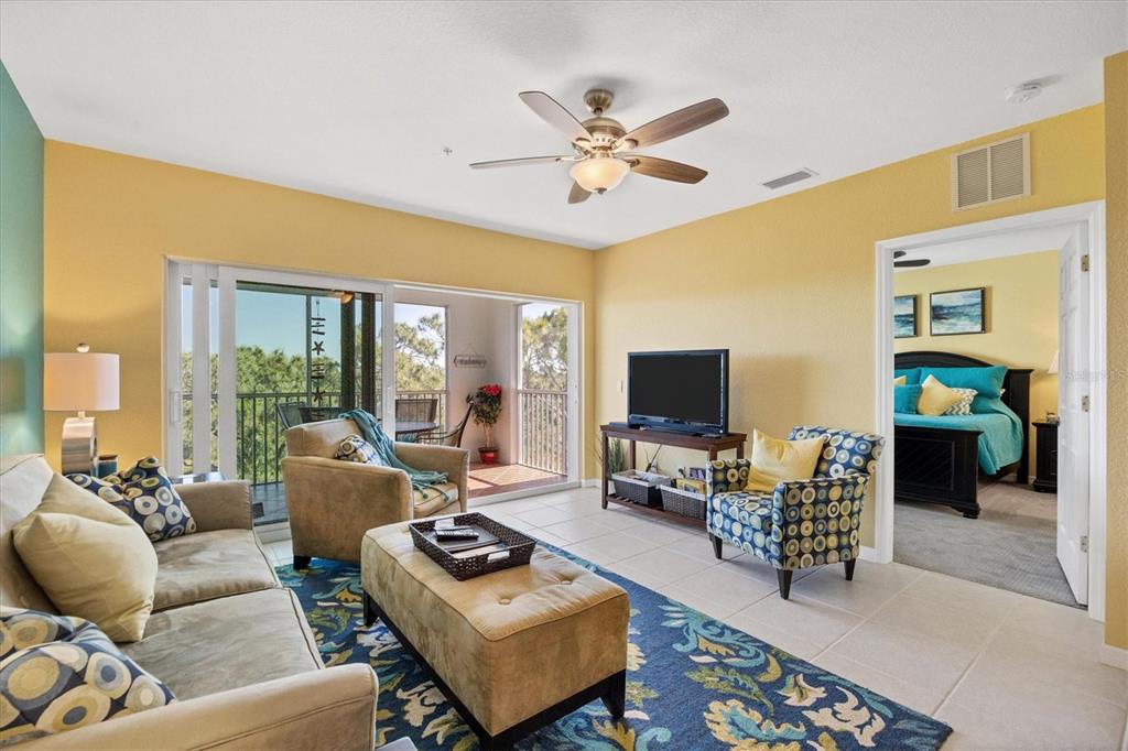 8413 Placida Road, Unit 407 Placida, FL 33946 - Photo 7 of 57 a living room with furniture and a flat screen tv