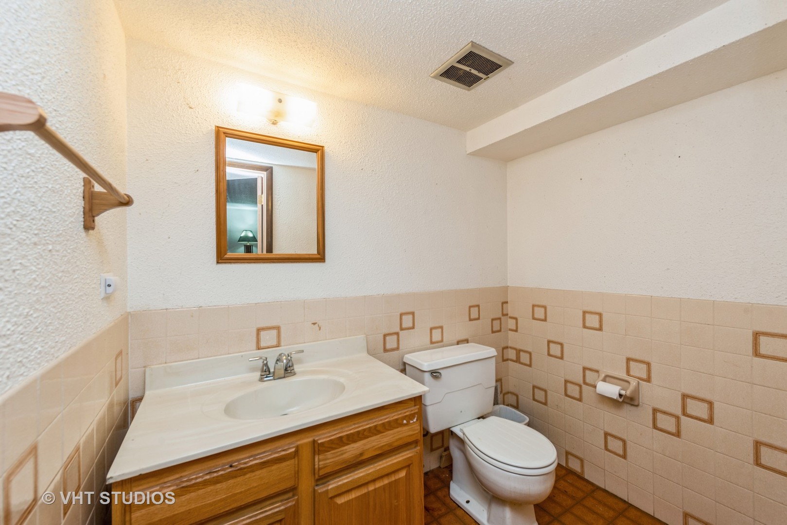 8308 Schmidt Street Spring Grove, IL 60081 - Photo 15 of 33 a bathroom with a sink a toilet and mirror
