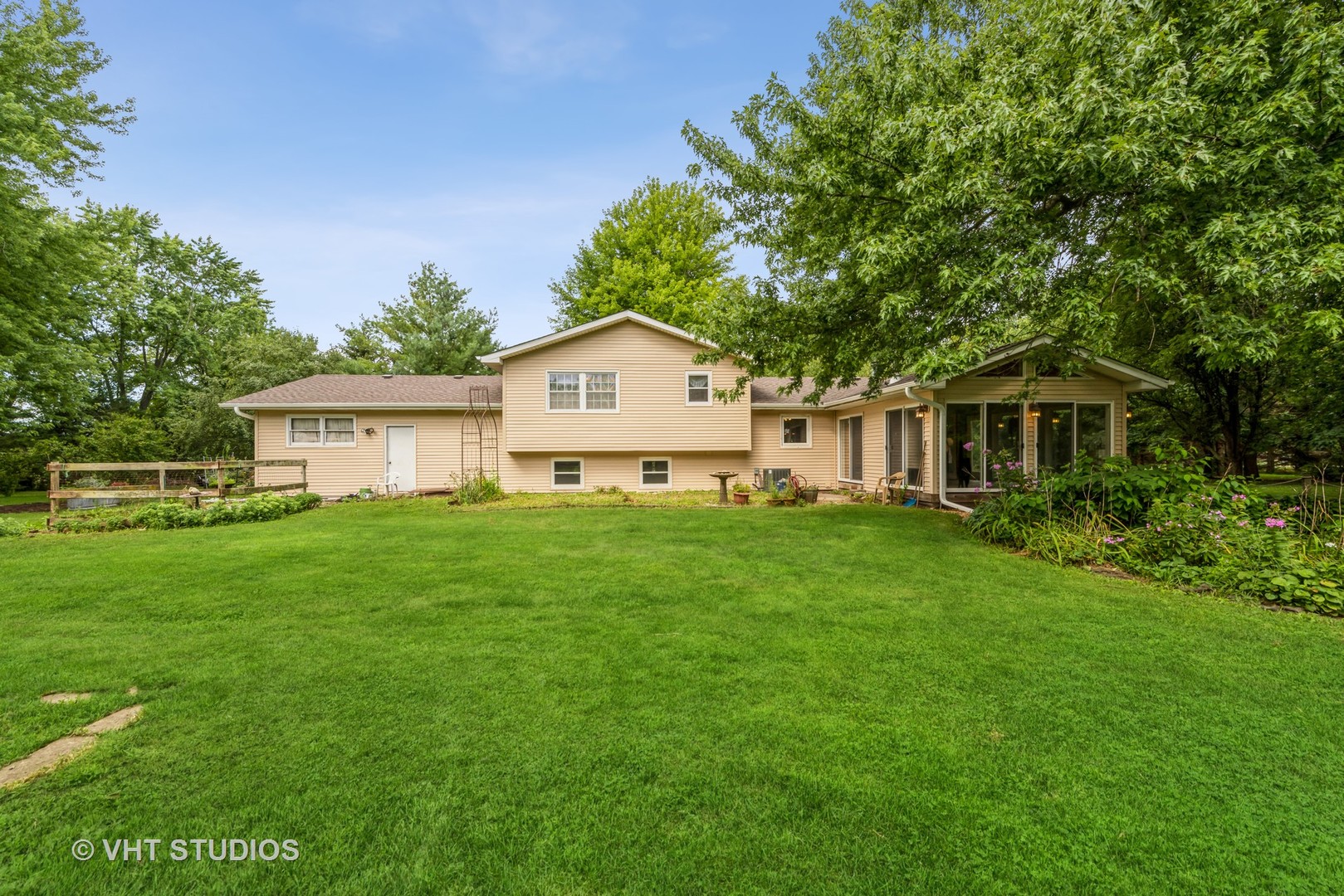 8308 Schmidt Street Spring Grove, IL 60081 - Photo 16 of 33 a front view of a house with a garden