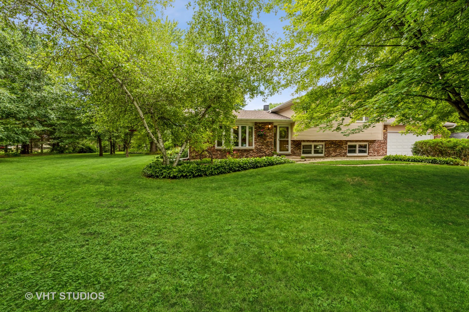 8308 Schmidt Street Spring Grove, IL 60081 - Photo 2 of 33 a front view of a house with a garden