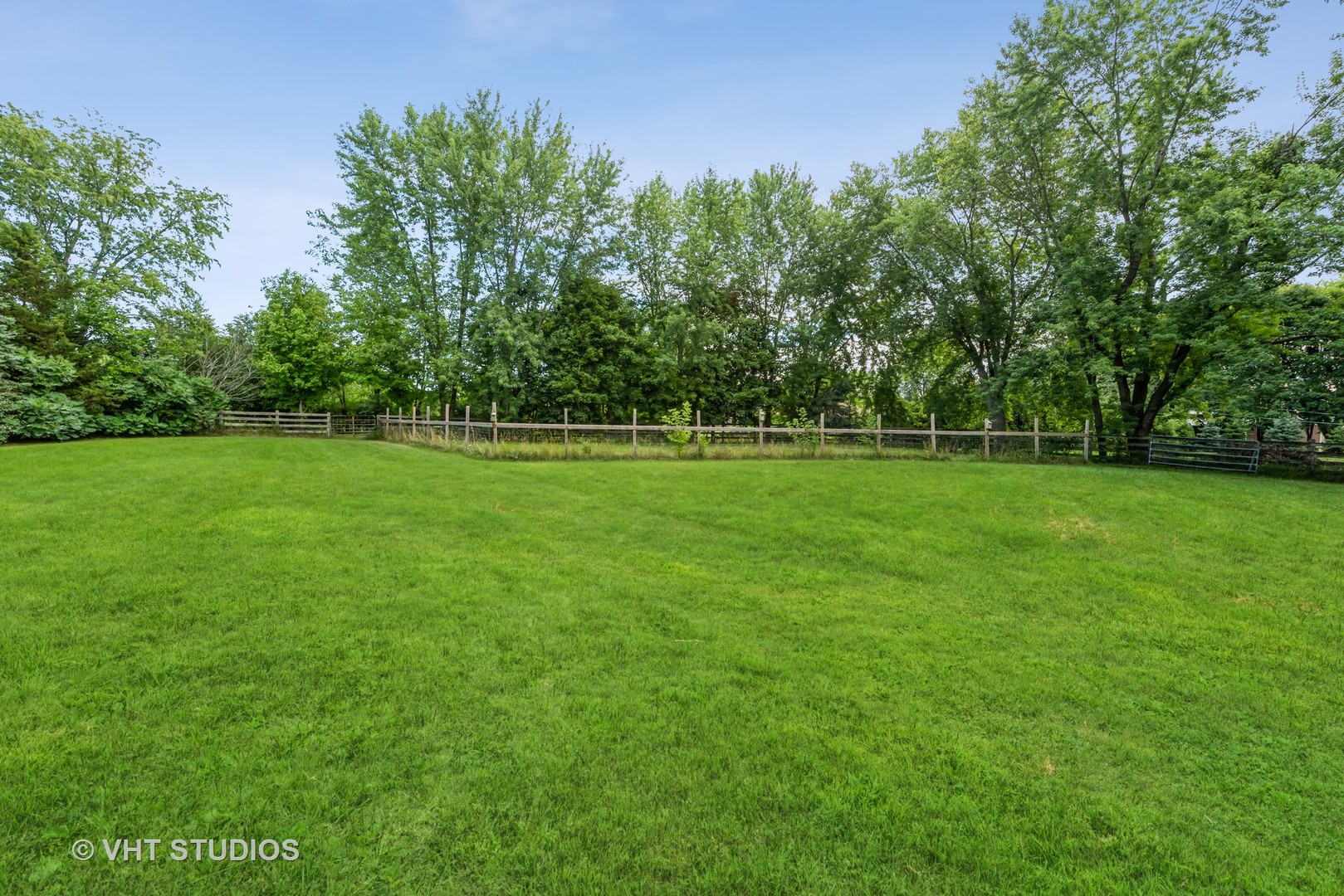 8308 Schmidt Street Spring Grove, IL 60081 - Photo 22 of 33 a view of a grassy field with trees in the background