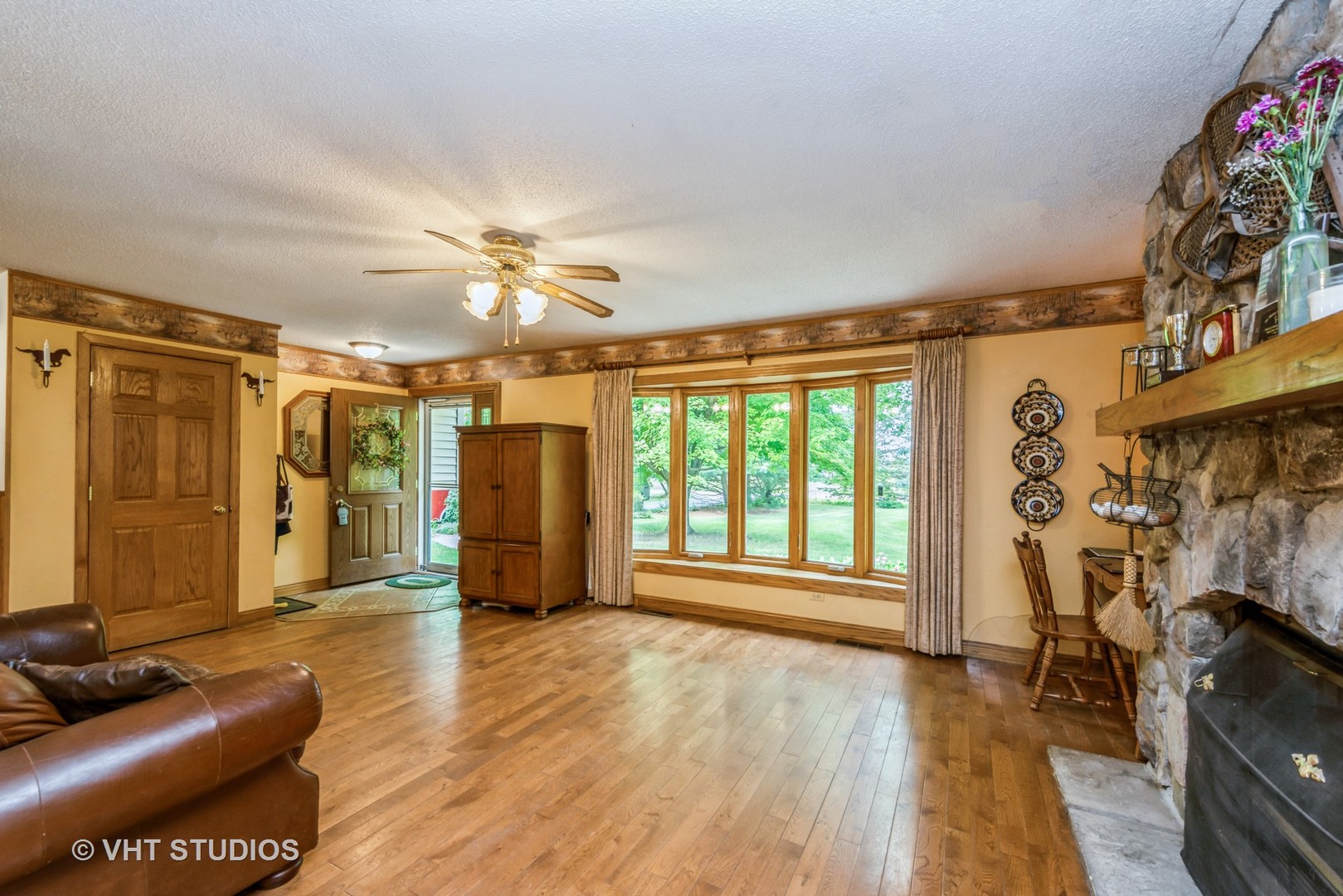 8308 Schmidt Street Spring Grove, IL 60081 - Photo 4 of 33 a view of livingroom with hardwood floor and a ceiling fan
