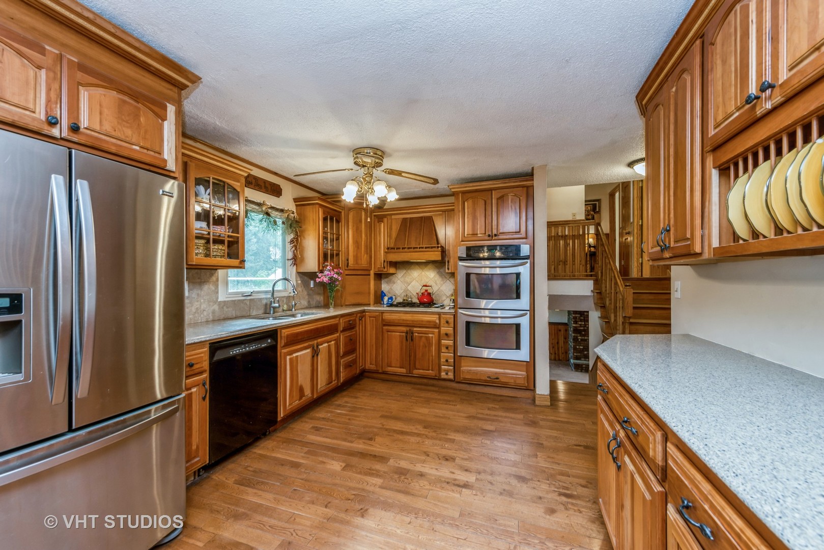 8308 Schmidt Street Spring Grove, IL 60081 - Photo 5 of 33 a kitchen with stainless steel appliances granite countertop a refrigerator and a stove top oven