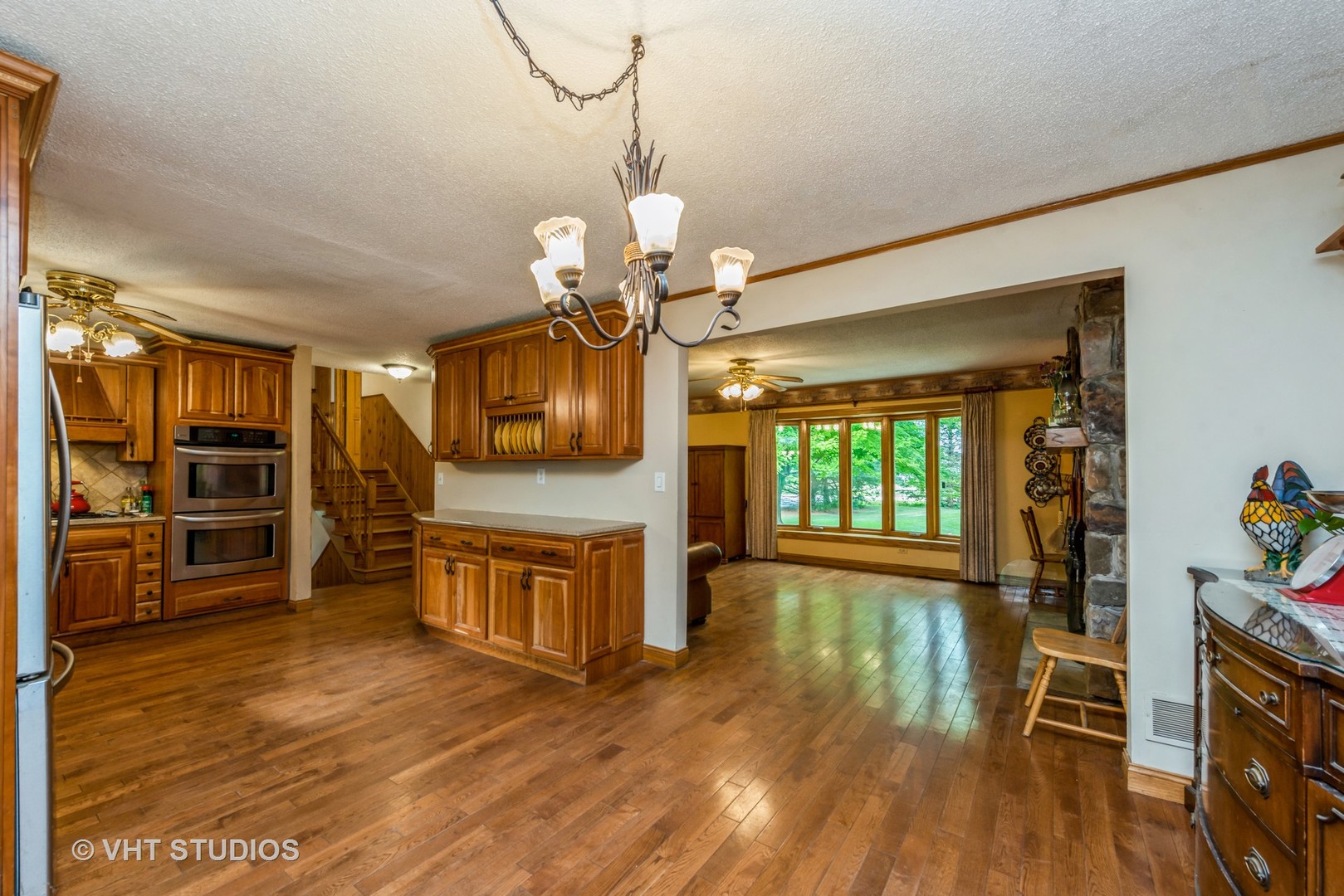 8308 Schmidt Street Spring Grove, IL 60081 - Photo 6 of 33 a view of a living room and kitchen with wooden floor