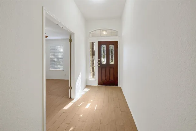 a view of a hallway with wooden floor