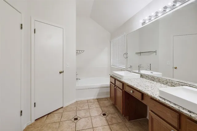 a bathroom with a granite countertop sink a toilet and shower