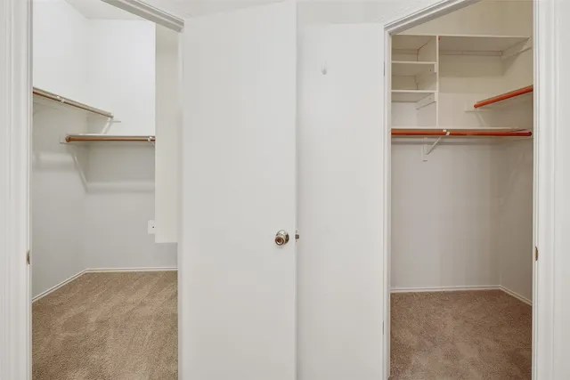 a view of walk in closet with empty racks