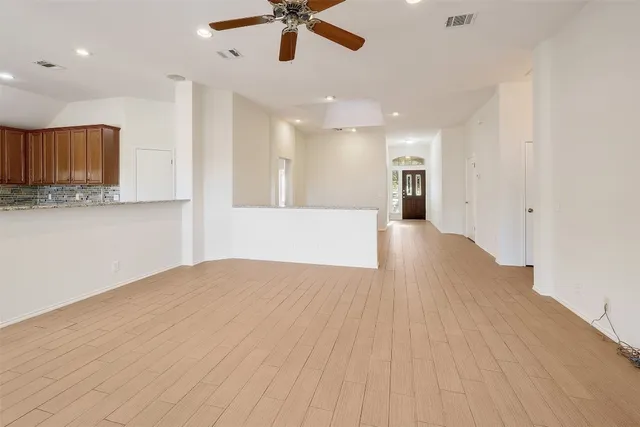 a view of a kitchen with a sink and a refrigerator