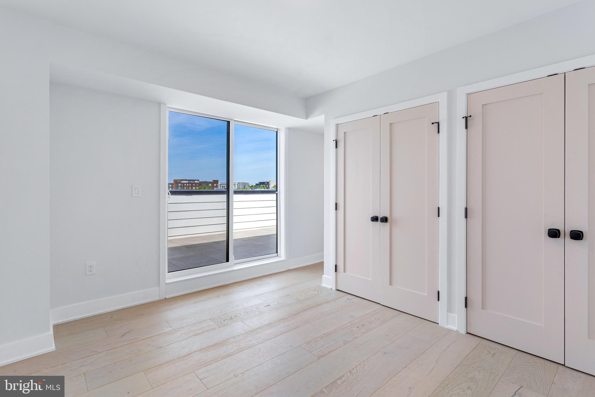 845 19th Street Northeast, Unit PH12 Washington, DC 20002 - Photo 17 of 23 a view of wooden floor and windows in a room