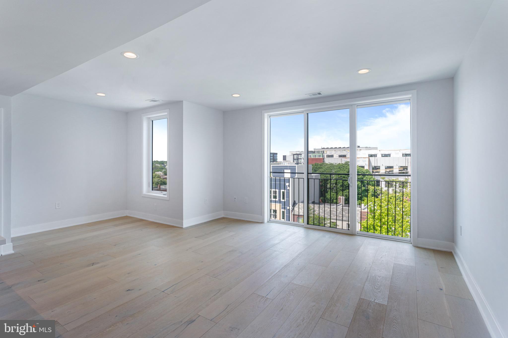 845 19th Street Northeast, Unit PH12 Washington, DC 20002 - Photo 5 of 23 an empty room with wooden floor and natural light
