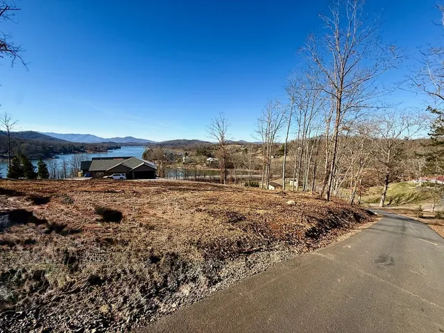 a view of a yard with wooden fence