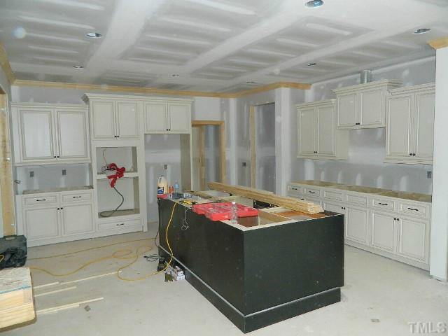 9404 Carlswood Court Raleigh, NC 27613 - Photo 4 of 20 a utility room with cabinets washer and dryer