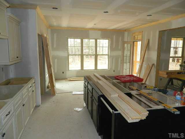 9404 Carlswood Court Raleigh, NC 27613 - Photo 5 of 20 a spacious bathroom with a granite countertop sink a large mirror and a bathtub