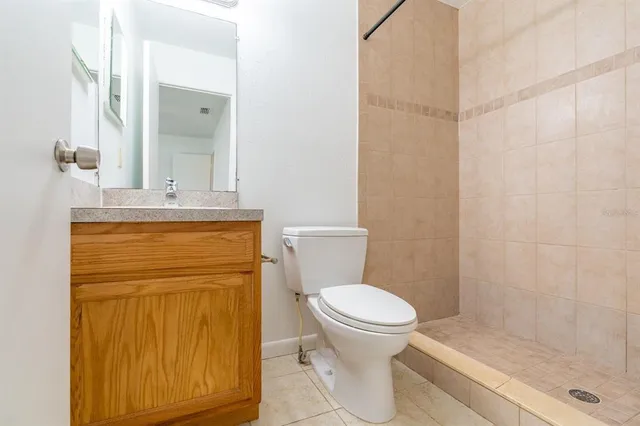 a bathroom with a toilet a sink and shower