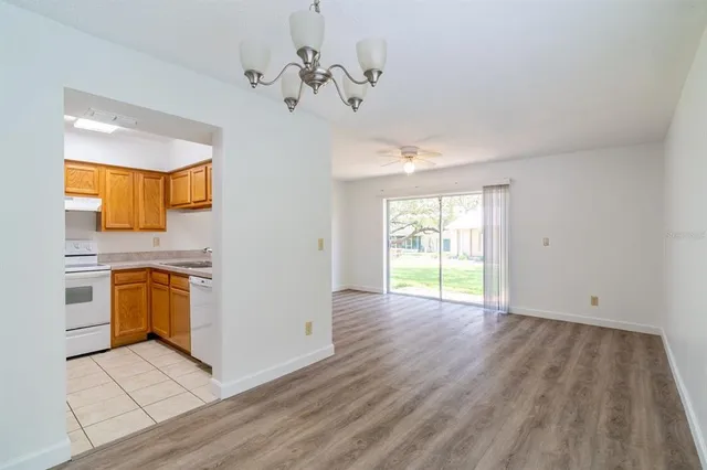 a view of a kitchen with a sink and dishwasher wooden floor