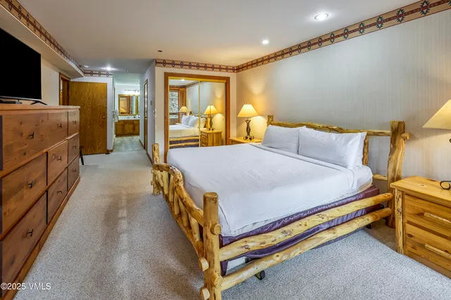 a bed room with a bed and a television