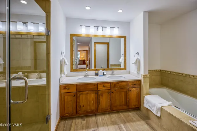a bathroom with a double vanity sink and a mirror