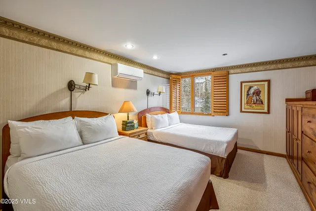 a bedroom with bed and a table