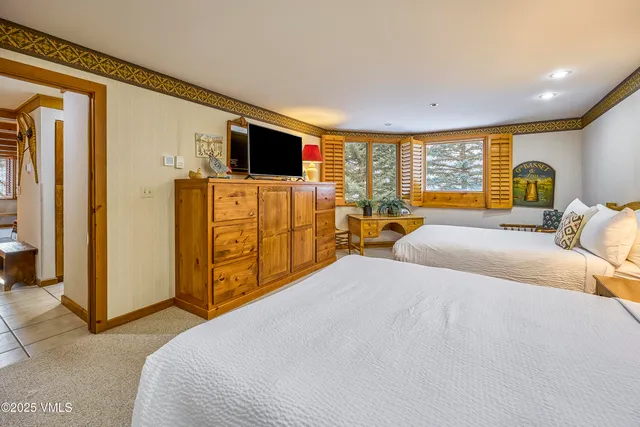 a bedroom with a bed and flat screen tv